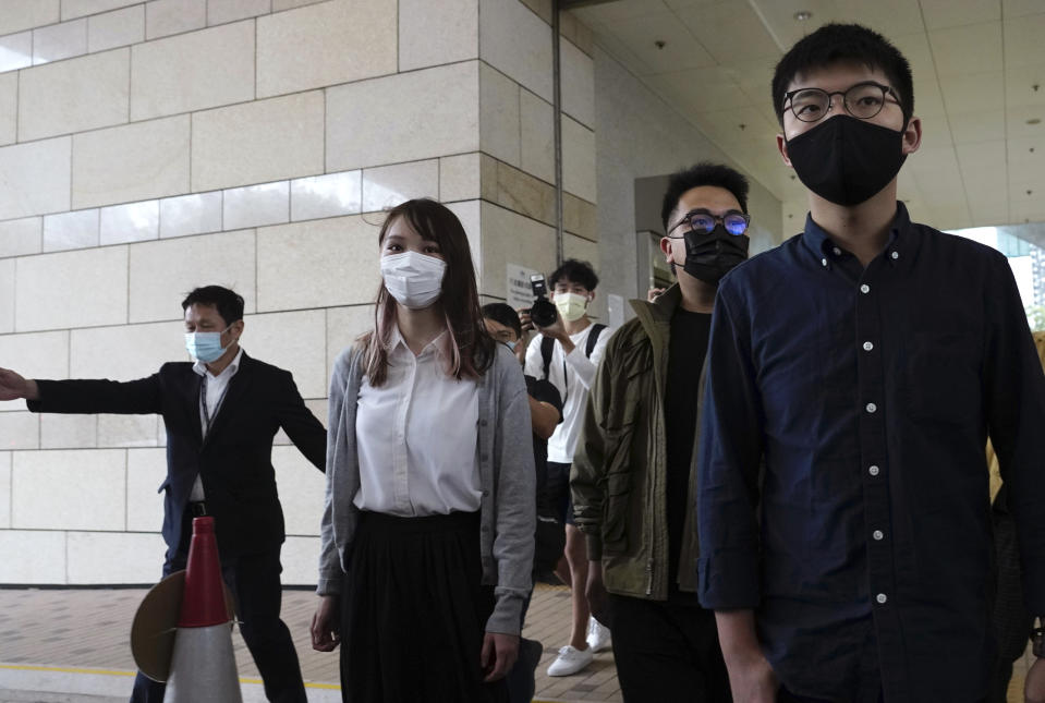 Hong Kong activists, from right, Joshua Wong, Ivan Lam and Agnes Chow arrive at a court in Hong Kong, Monday, Nov. 22. 2020. The trio appears at court for their trial as they face charges related to the besieging of a police station during anti-government protests last year. (AP Photo/Vincent Yu)