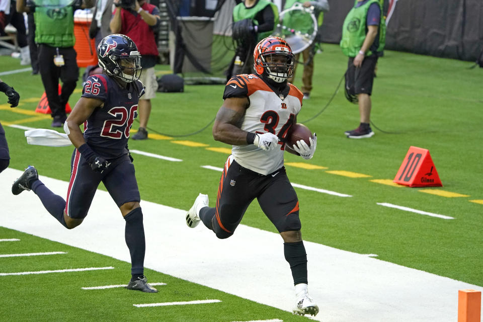 Cincinnati Bengals running back Samaje Perine (34) rushes for a touchdown as Houston Texans cornerback Vernon Hargreaves III (26) defends during the second half of an NFL football game Sunday, Dec. 27, 2020, in Houston. (AP Photo/Sam Craft)