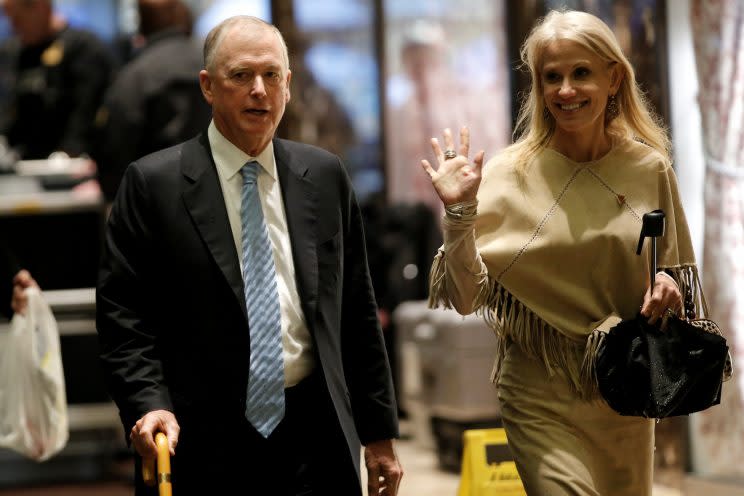 Former Vice President Dan Quayle and Kellyanne Conway, President-elect Donald Trump's senior adviser, walk through the lobby at Trump Tower on Tuesday. (Mike Segar/Reuters)