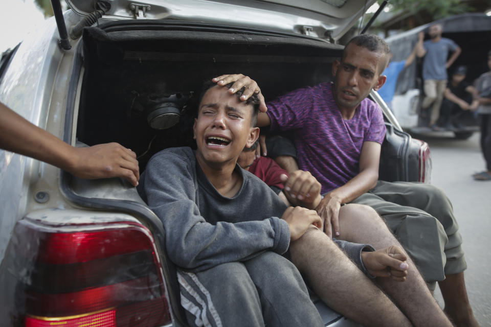 Palestinians mourn their relatives killed in the Israeli bombardment of the Gaza Strip at a hospital morgue in Khan Younis, southern Gaza Strip, Monday, June 24, 2024. (AP Photo/Jehad Alshrafi)