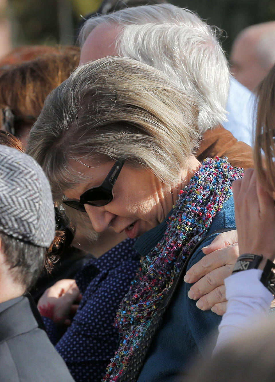 Tucson shooting survivor Pam Simon lowers her head during a remembrance ceremony on the third anniversary of the Tucson shootings, Wednesday, Jan. 8, 2014, in Tucson, Ariz. Six people were killed and 13 wounded, including U.S. Rep. Gabrielle Giffords, D-Ariz., in the shooting rampage at a community event hosted by Giffords in 2011. Jared Lee Loughner was sentenced in November 2012 to seven consecutive life sentences, plus 140 years, after he pleaded guilty to 19 federal charges in the shooting. (AP Photo/Matt York)