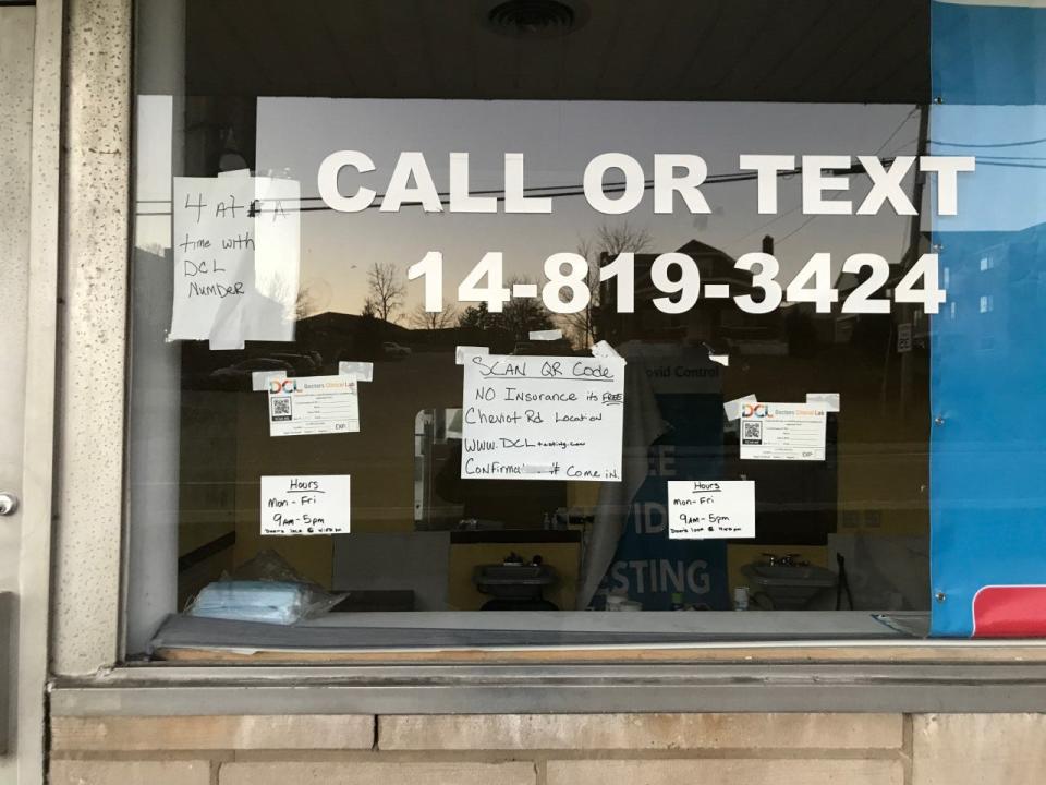 Signs on the window of the Center for COVID Control testing site in White Oak on Jan. 12, 2022.