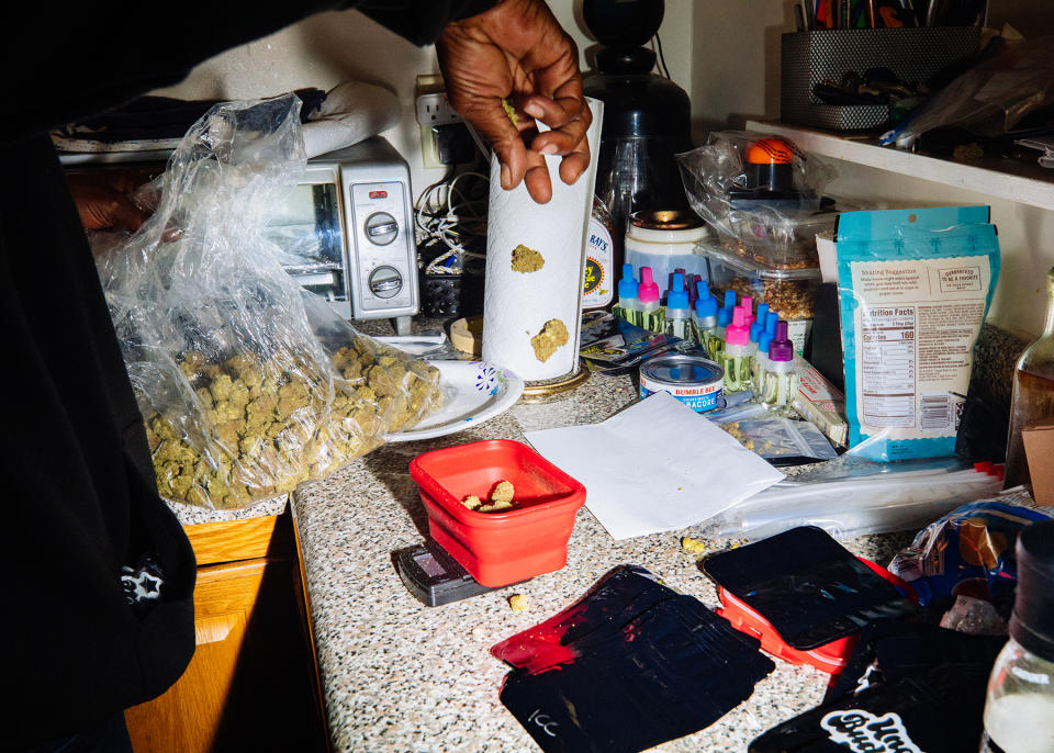 A worker weighs marijuana at the Uncle Budd's headquarters in West Harlem, NYC on October 21, 2022.