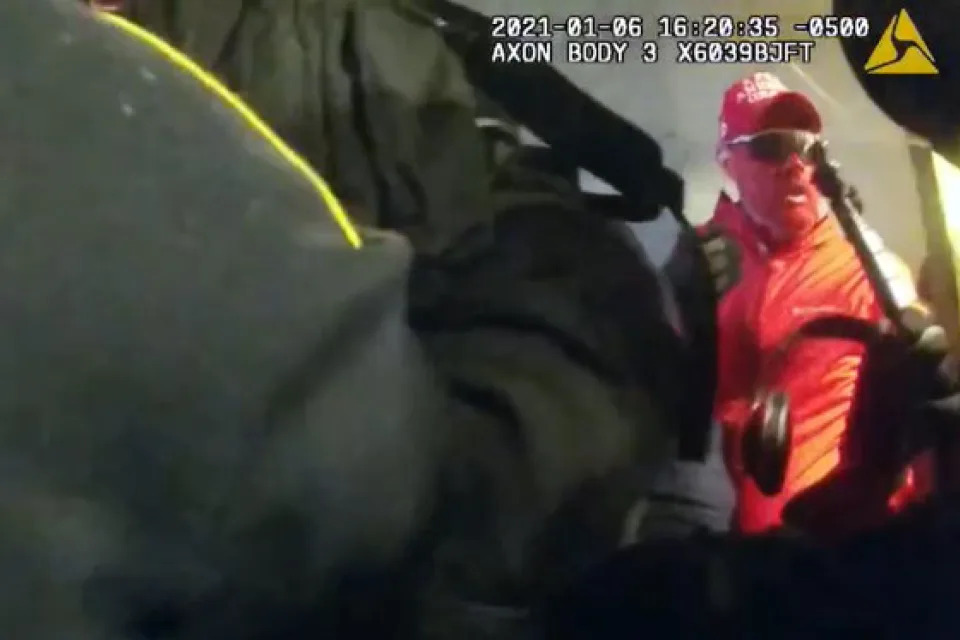 This image from video contained in the statement of facts supporting the arrest warrant for Rally Runner, a St. Louis Cardinals superfan who legally changed his name from Daniel Donnelly Jr., shows Rally Runner at an entrance to the U.S. Capitol during the Jan. 6, 2021, riot. (Justice Department via AP)