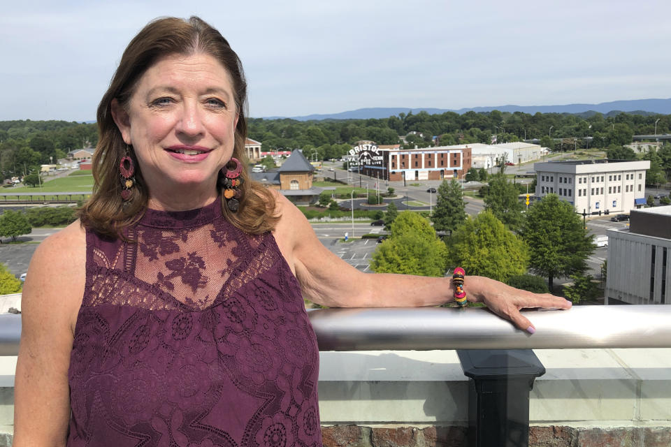 In this June 26, 2019 photo, Carolyn Sliger, rural programs coordinator at the Quillen College of Medicine at East Tennessee State University, poses at the rooftop bar at The Bristol Hotel in Bristol, Va. Ten medical students were on a tour of the city organized by a medical school with the aim of luring them to practice in rural communities facing health care shortages after graduation. (AP Photo/Sudhin Thanawala)