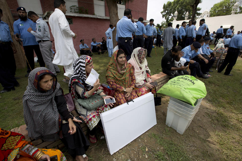 Pakistani election staff wait for a transport to carry material to polling stations at a distribution center in Islamabad, Pakistan, Tuesday, July 24, 2018. Pakistan will hold Parliamentary elections Wednesday. (AP Photo/B.K. Bangash)