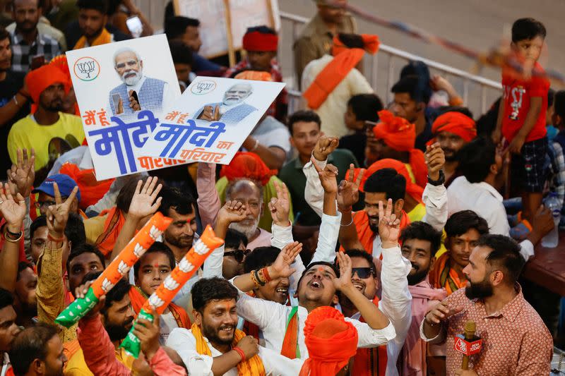 FILE PHOTO: Supporters of India's Prime Minister Narendra Modi react, on the day of a Bharatiya Janata Party (BJP) election campaign rally in Ayodhya