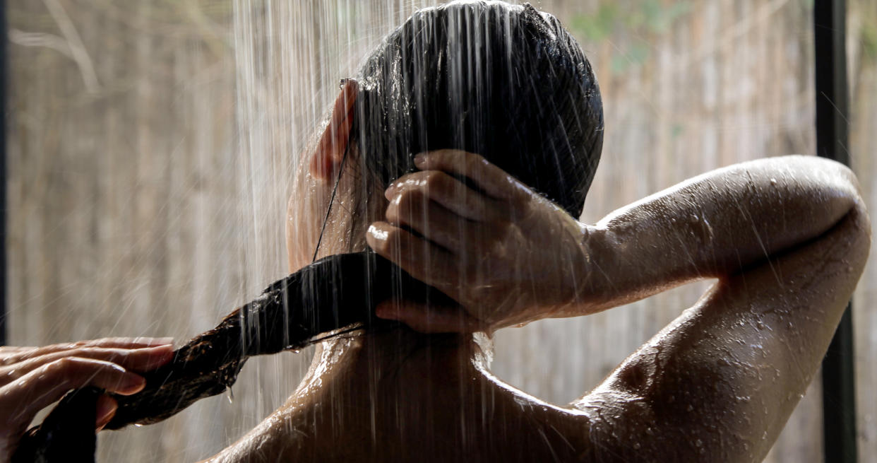 A woman showering. (PHOTO: Getty Images)