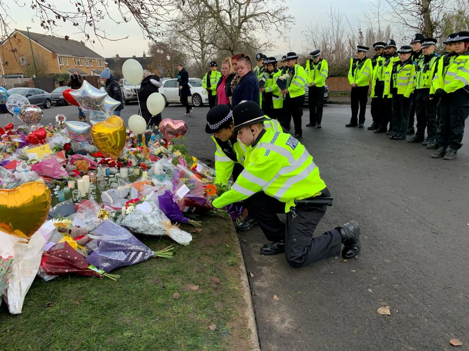 21 Officers from West Midlands Police lay bouquets of flowers and stood in silence near to the scene in Babbs Mill Park in Kingshurst, Solihull, after the deaths of three boys aged eight, 10 and 11 who fell through ice into a lake in the West Midlands. Picture date: Tuesday December 13, 2022. (Photo by Richard Vernalls/PA Images via Getty Images)