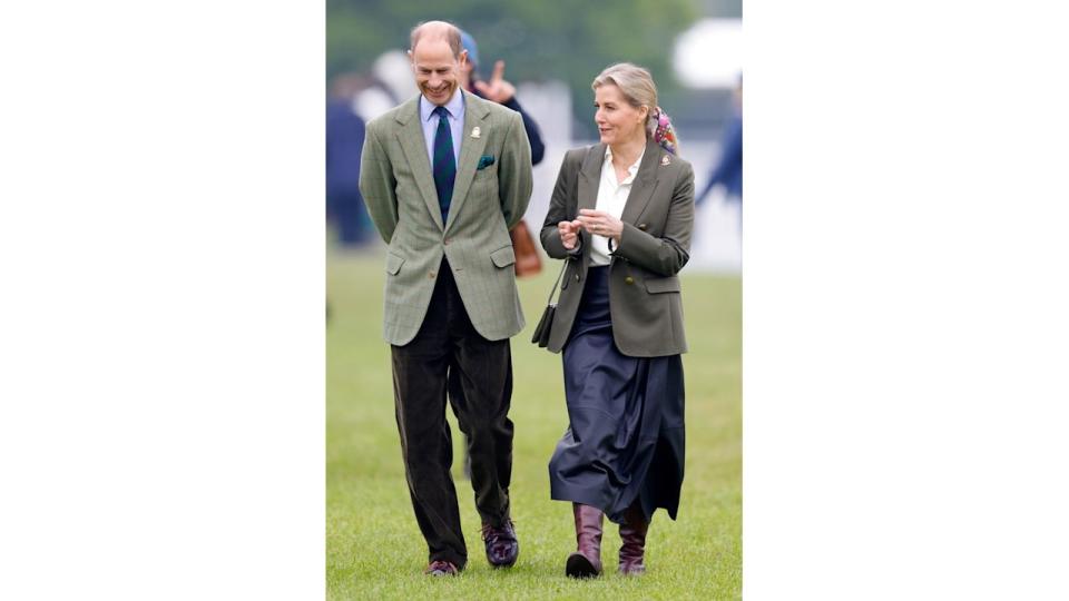 Sophie in a leather skirt walking with Prince Edward