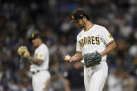 San Diego Padres starting pitcher Yu Darvish (11) looks down at the ball after getting his 1,500th career strikeout during the fifth inning of a baseball game against the Los Angeles Dodgers, Monday, June 21, 2021, in San Diego. (AP Photo/Denis Poroy)