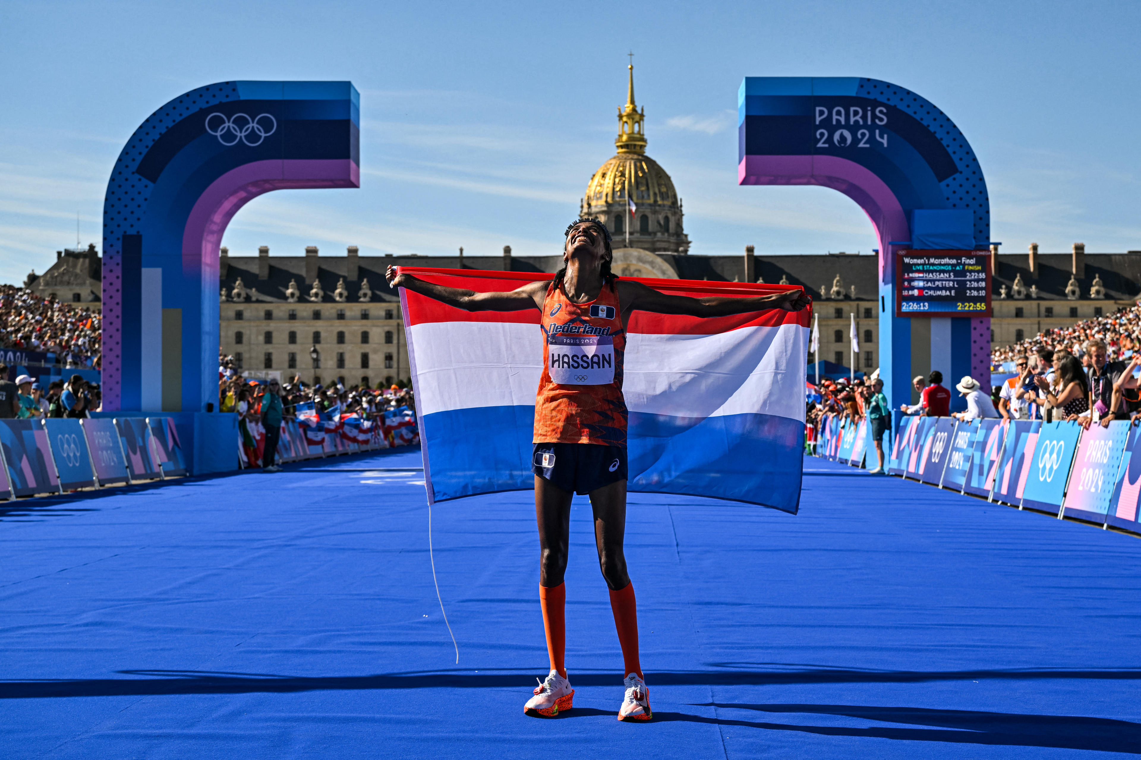 TOPSHOT - Gold medalist Sifan Hassan of the Netherlands celebrates after crossing the finish line first during the women's marathon of the athletics event of the Paris 2024 Olympic Games at the Invalides in Paris on August 11, 2024. (Photo by Andrej ISAKOVIC / AFP) (Photo by ANDREJ ISAKOVIC/AFP via Getty Images)