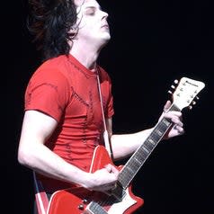 Jack White playing the guitar onstage