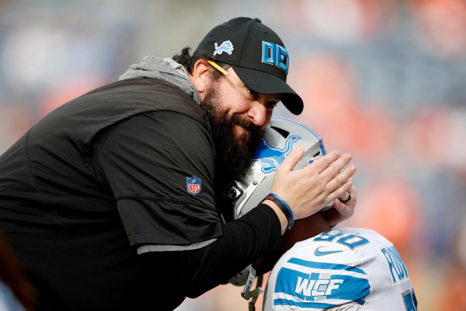 Lions coach Matt Patricia talks with defensive end Trey Flowers prior to the game against the Broncos on Sunday, Dec. 22, 2019, in Denver.