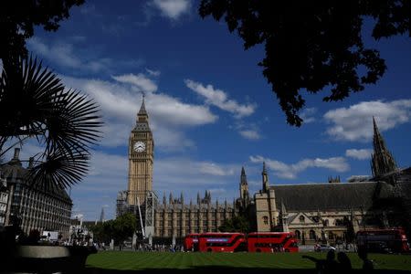 Tourists view the Elizabeth Tower, which houses the Great Clock and the 'Big Ben' bell, at the Houses of Parliament, in central London, Britain, August 16, 2017. REUTERS/Toby Melville