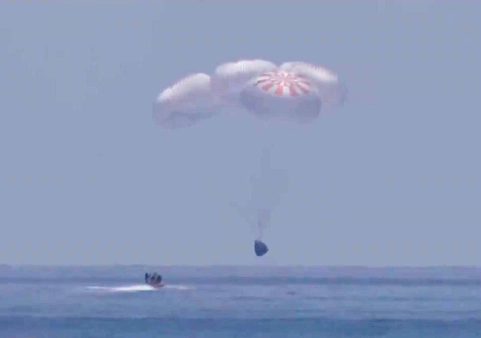 GULF OF MEXICO - AUGUST 2: In this screen grab from NASA TV,  SpaceX 's Crew Dragon capsule spacecraft just before it splashes down in to the water after completing NASA's SpaceX Demo-2 mission to the International Space Station with NASA astronauts Robert Behnken and Douglas Hurley onboard, August 2, 2020 off the coast of Pensacola, Florida in the Gulf of Mexico. The Demo-2 mission is the first launch with astronauts of the SpaceX Crew Dragon spacecraft and Falcon 9 rocket to the International Space Station as part of the agency's Commercial Crew Program. The test flight serves as an end-to-end demonstration of SpaceXs crew transportation system. Behnken and Hurley launched at 3:22 p.m. EDT on Saturday, May 30, from Launch Complex 39A at the Kennedy Space Center. A new era of human spaceflight is set to begin as American astronauts once again launch on an American rocket from American soil to low-Earth orbit for the first time since the conclusion of the Space Shuttle Program in 2011.   (Photo by NASA via Getty Images)