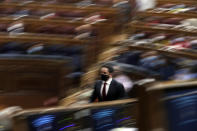 Vox party leader Santiago Abascal walks to the tribune to give a speech during a parliamentary session in Madrid, Spain, Wednesday Oct. 21, 2020. Spanish Prime Minister Pedro Sanchez faces a no confidence vote in Parliament put forth by the far right opposition party VOX. (AP Photo/Manu Fernandez, Pool)