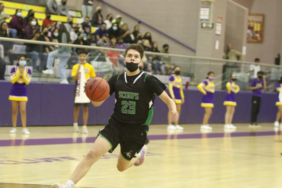 Farmington High School's Cayden Yazzie looks to the basket on a breakaway during a game against Kirtland Central, Tuesday, Dec. 7, 2021 at Bronco Arena.