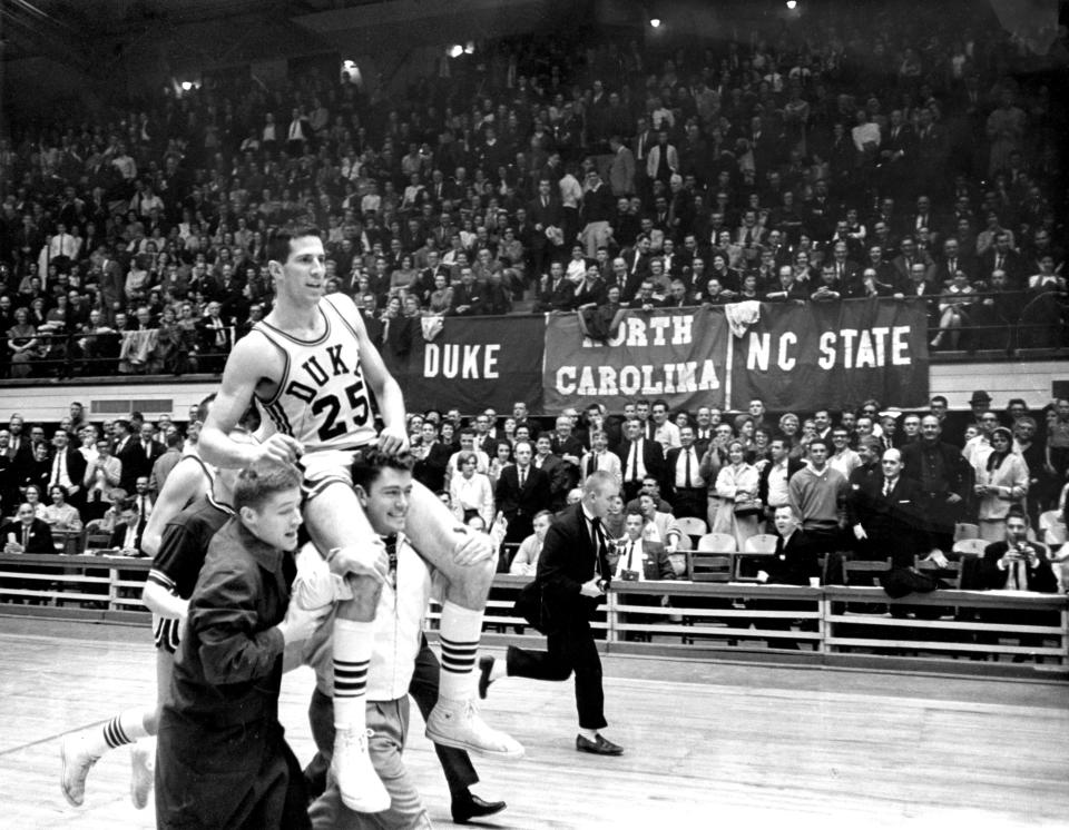 FILE - Duke NCAA college basketball player Art Heyman (25) is carried by teammates in Durham, N.C., in 1963. (The Herald-Sun via AP, File)