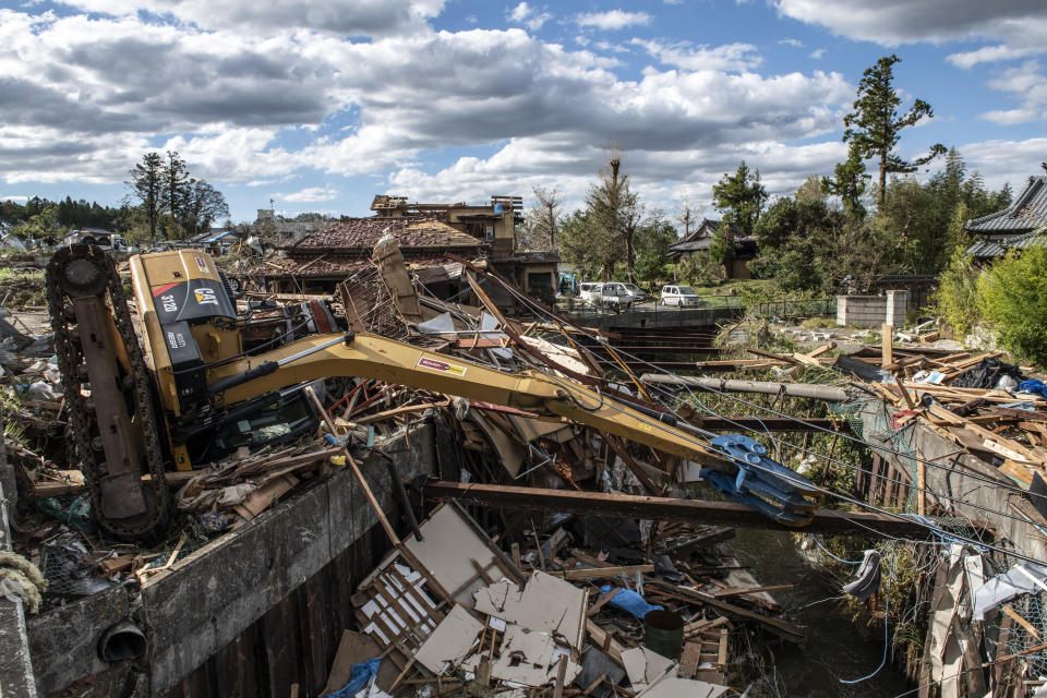 A digger lies across an embankment after being blown over by a tornado shortly before the arrival of Typhoon Hagibis, on Oct. 13, 2019, in Chiba, Japan. (Photo: Carl Court/Getty Images)