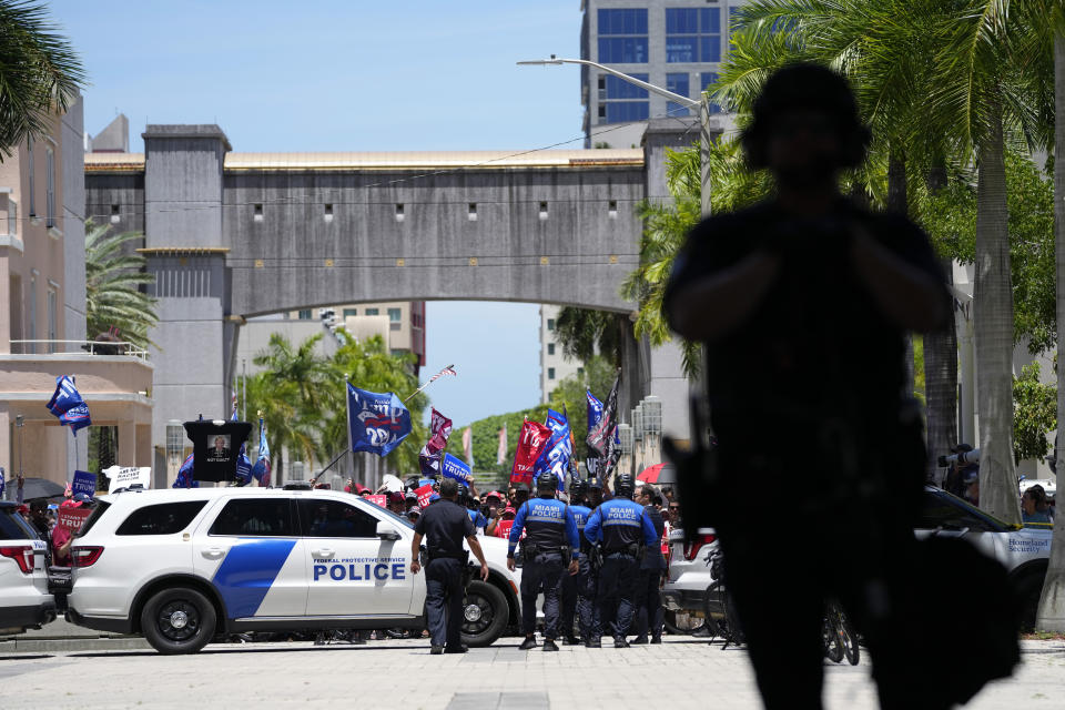 Authorities stand guard outside the Wilkie D. Ferguson Jr. U.S. Courthouse, Tuesday, June 13, 2023, in Miami, after former President Donald Trump arrived at the federal court. Trump is making a federal court appearance on dozens of felony charges accusing him of illegally hoarding classified documents and thwarting the Justice Department's efforts to get the records back. (AP Photo/Alex Brandon)