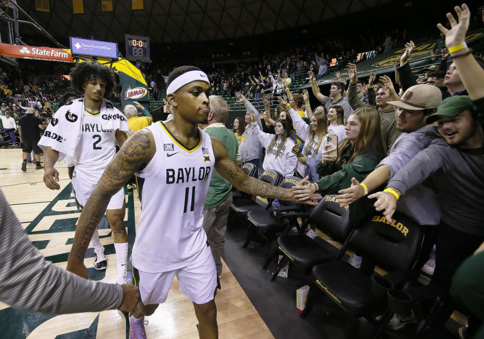 Baylor guard James Akinjo high fives fans following an NCAA college basketball game against Villanova on Sunday, Dec. 12, 2021, in Waco, Texas. (AP Photo/Ray Carlin)