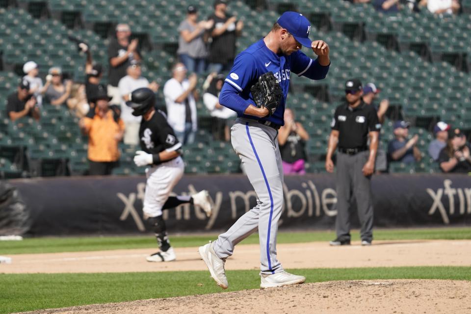 Kansas City Royals relief pitcher Anthony Misiewicz walks back onto the mound as Chicago White Sox's AJ Pollock, rear, rounds the bases after hitting a two-run home run in the eighth inning of a baseball game in Chicago, Thursday, Sept. 1, 2022. (AP Photo/Nam Y. Huh)