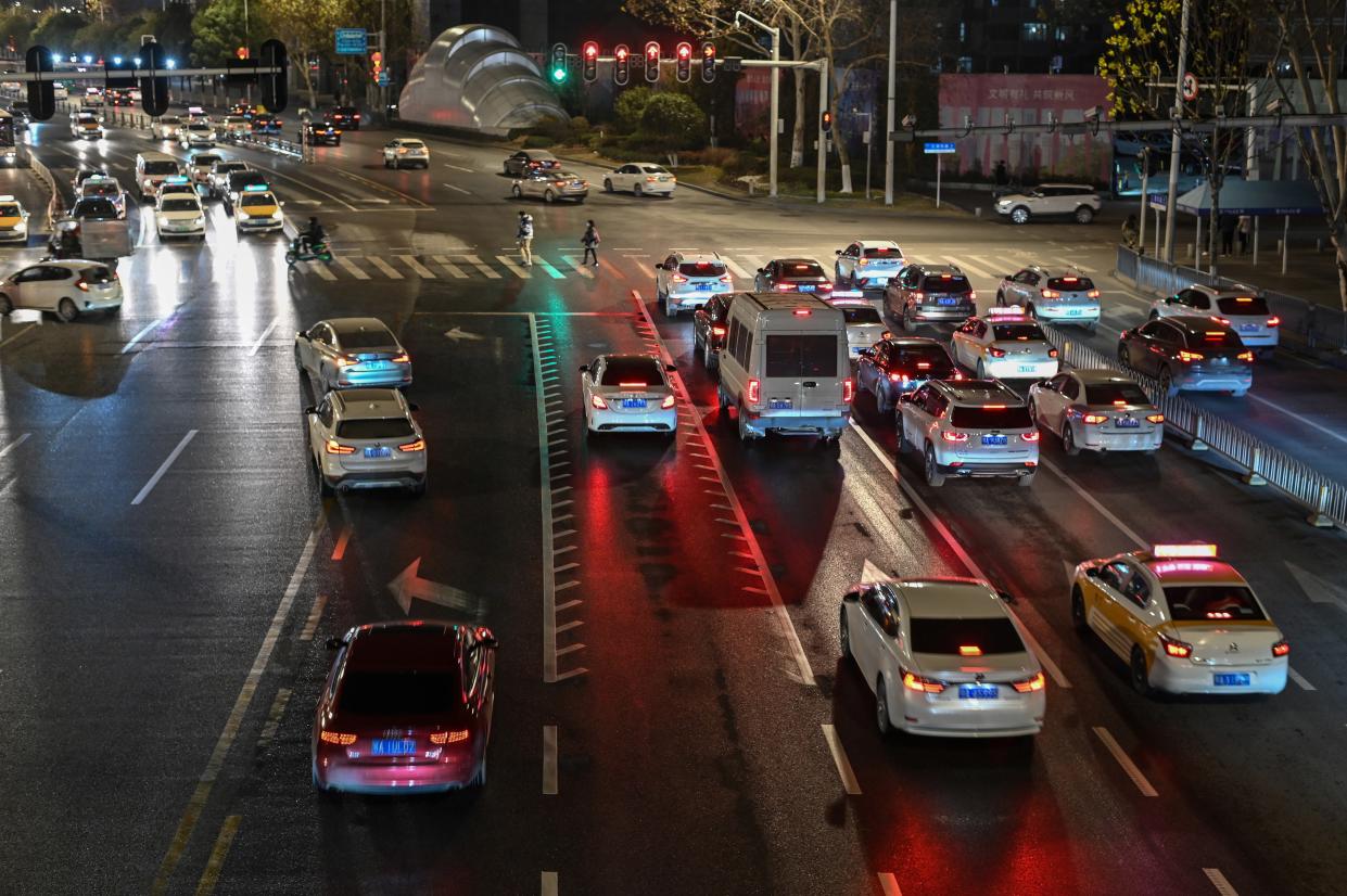 File: This photo taken on 19 January 2021 shows a general view of traffic stopped at a red light on a street in Wuhan, China (AFP via Getty Images)