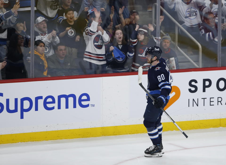 Winnipeg Jets' Pierre-Luc Dubois (80) and fans celebrate after he scored on a penalty shot against Vancouver Canucks goaltender Collin Delia during second-period NHL hockey game action in Winnipeg, Manitoba, Thursday, Dec. 29, 2022. (John Woods/The Canadian Press via AP)