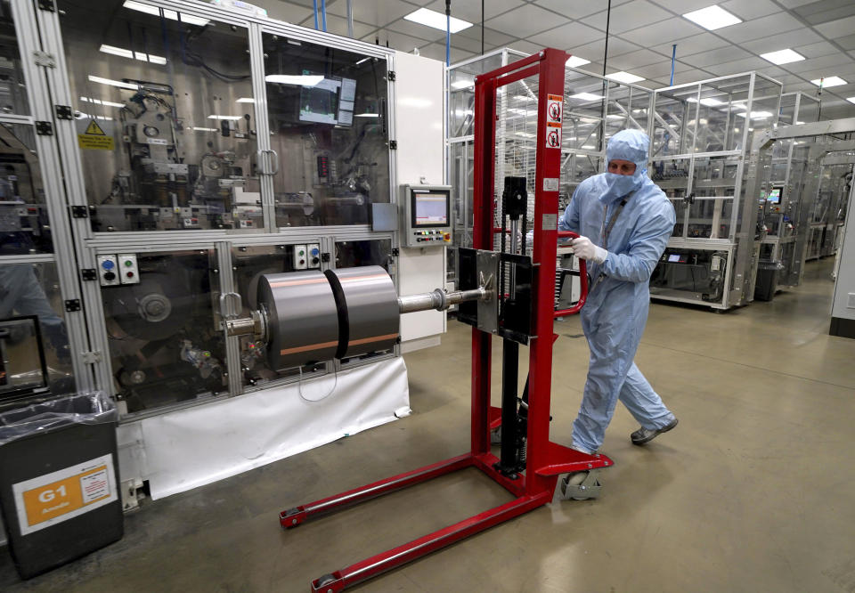 A worker moves components used in the manufacture of the battery for the Nissan Leaf at the Envision AESC UK Ltd battery plant based at Nissan, in Sunderland, England, Thursday July 1, 2021. Japanese carmaker Nissan and two partners announced plans to invest 1 billion ($1.4 billion) pounds to produce a new model of an all-electric vehicle and batteries in northeast England, a major victory for the U.K. government’s efforts to attract jobs and investment following the country’s departure from the European Union. (Owen Humphreys/PA via AP)