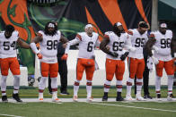 Cleveland Browns quarterback Baker Mayfield (6) locks arms with teammates during the national anthem before an NFL football game against the Cincinnati Bengals, Sunday, Oct. 25, 2020, in Cincinnati. (AP Photo/Michael Conroy)