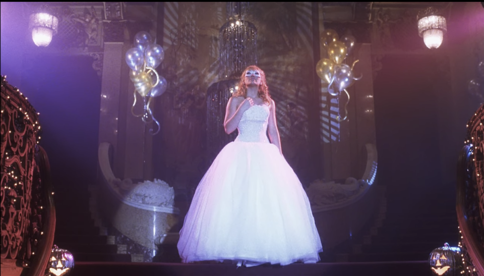 Sam at the top of the stairs at the venue in a huge white ballgown