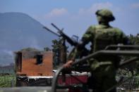 <p>A soldier looks at the site after a series of explosions at fireworks warehouses in Tultepec, central Mexico, on July 5, 2018. – At least 17 people were killed, including rescue workers who died saving others’ lives, officials said. The initial explosion occurred around 9:30 am (1430 GMT), then spread to other warehouses just as police and firefighters began attending to the first victims. (Photo: Pedro Pardo/AFP/Getty Images) </p>