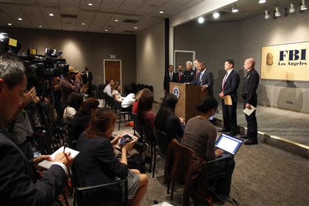 Law enforcement officials talk to reporters at a news conference regarding a shooting incident that occurred the previous day at Los Angeles airport (LAX), in Los Angeles, California November 2, 2013. REUTERS/David McNew