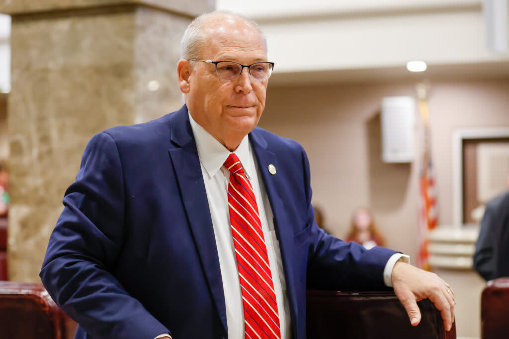 A man in a blue jacket and red tie.