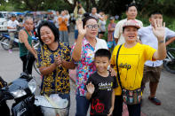 <p>Onlookers wave as an ambulance carrying rescued schoolboys leaves a military airport in Chiang Rai, Thailand, July 10, 2018. (Photo: Tyrone Siu/Reuters) </p>