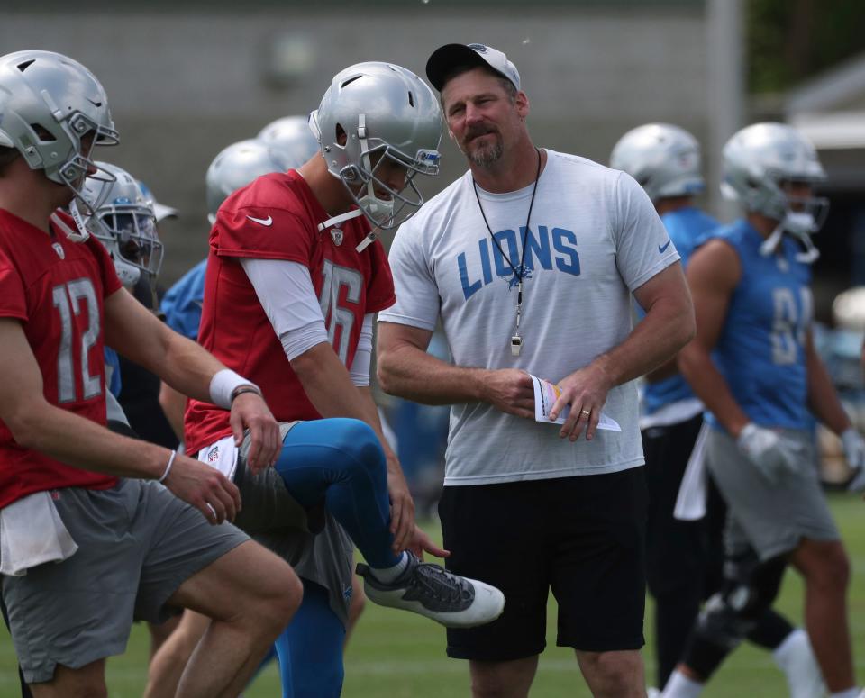 Lions coach Dan Campbell watches players, including quarterback Jared Goff (16) stretch during practice during minicamp on Thursday, June 9, 2022, in Allen Park.