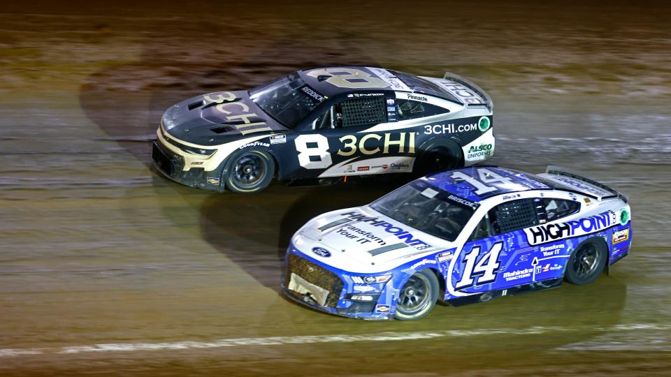 Driver Chase Briscoe (14) gets loose as he and driver Tyler Reddick (8) race into turn 4 during a NASCAR Cup Series auto race, Sunday, April 17, 2022, in Bristol, Tenn. (AP Photo/Wade Payne)