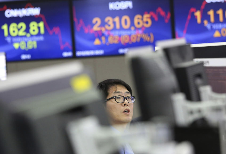 In this Aug. 30, 2018, file photo, a currency trader watches monitors at the foreign exchange dealing room of the KEB Hana Bank headquarters in Seoul, South Korea. Asian markets were mixed Thursday as positive sentiment from U.S. economic data and the country's willingness to strike a trade deal with Canada was shaken by a weaker dollar. (AP Photo/Ahn Young-joon, File)