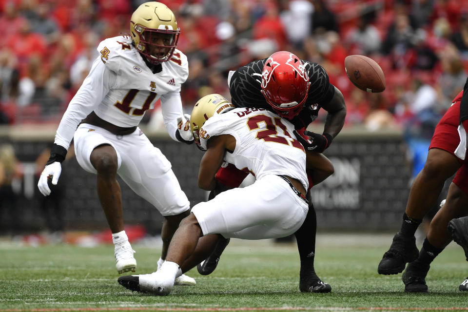 Boston College defensive back Josh DeBerry (21) hits Louisville running back Hassan Hall (19) causing a fumble during the first half of an NCAA college football game in Louisville, Ky., Saturday, Oct. 23, 2021. (AP Photo/Timothy D. Easley)