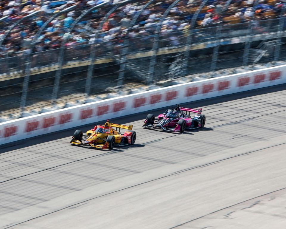 Romain Grosjean and Helio Castroneves race in the IndyCar Hy-Vee Salute To Farmers 300 at the Iowa Speedway in Newton.