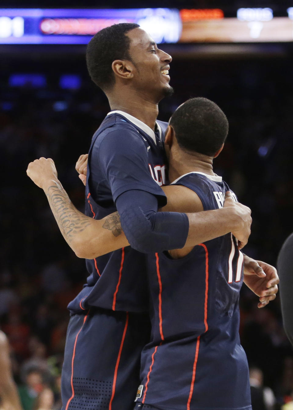 Connecticut's DeAndre Daniels, left, hugs teammate Ryan Boatright after Connecticut defeated Iowa State 81-76 in a regional semifinal of the NCAA men's college basketball tournament Friday, March 28, 2014, in New York. (AP Photo/Frank Franklin II)