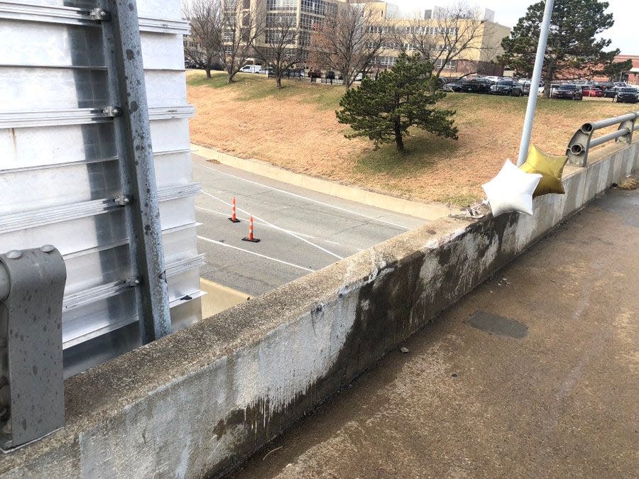 The south side of S.E. 6th Avenue's bridge over Interstate 70 remained without some of its railing Monday after a car smashed through that railing Sunday.