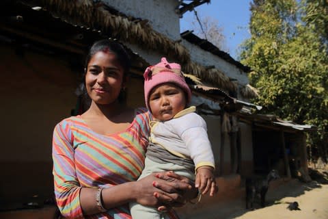 18 year old Anita Ghatani with her 6 month old son Anand in Kafle village - Credit: Bikram Rai&nbsp;