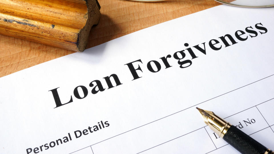 Loan forgiveness form on a wooden table.