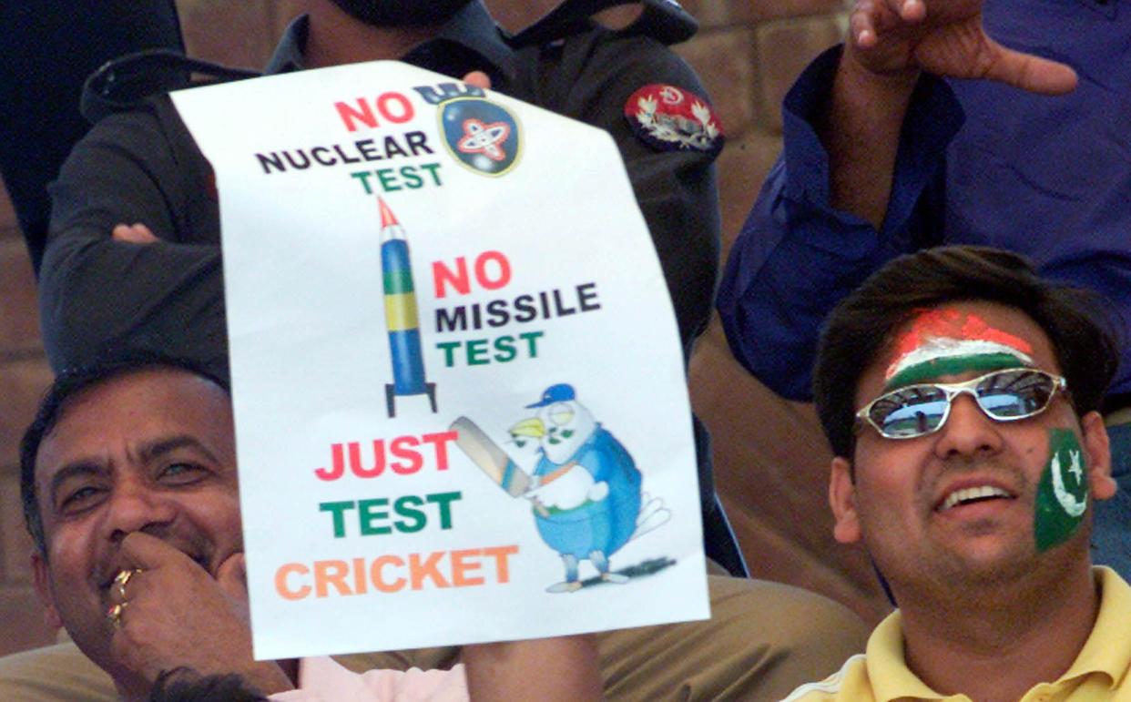 A Pakistani cricket fan holds up a friendship banner on the second day of the second cricket test match between India and Pakistan in Lahore, Pakistan, Tuesday, April 6, 2004. (AP Photo/KM Chaudhry)