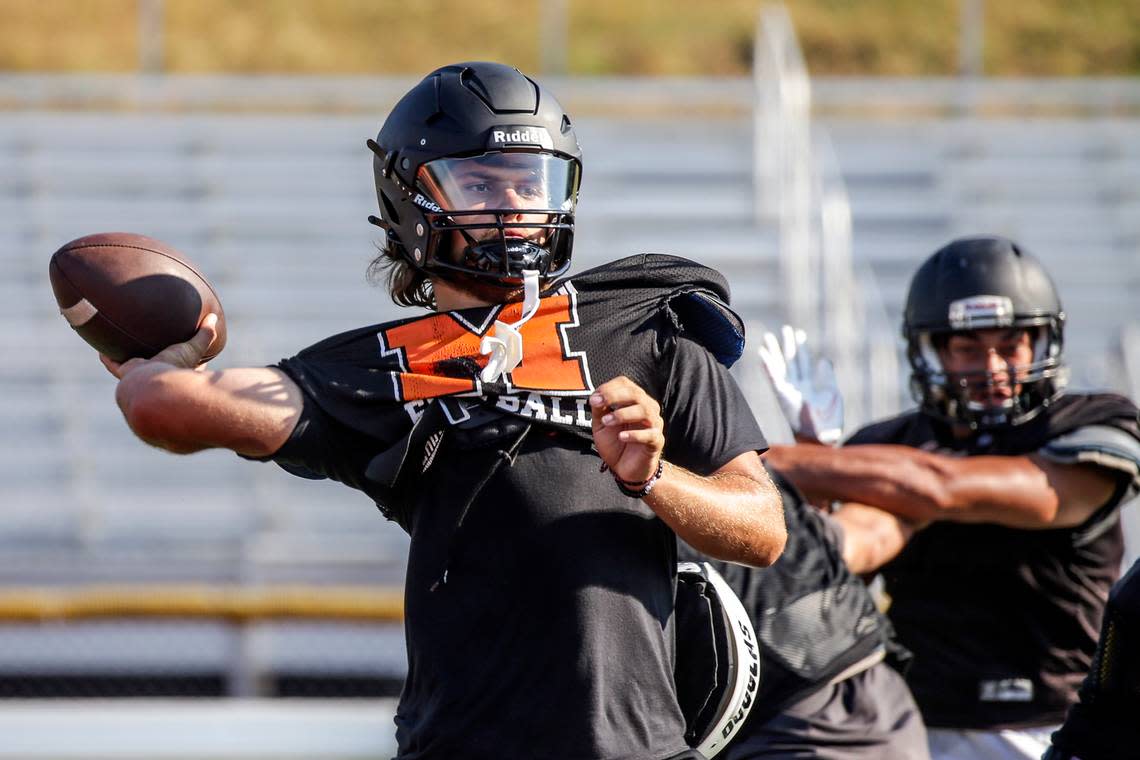 Blake Springer draws back for a pass during practice at Monroe High School Tuesday afternoon in Monroe, Washington on August 30, 2022. (Kevin Clark / The Herald)