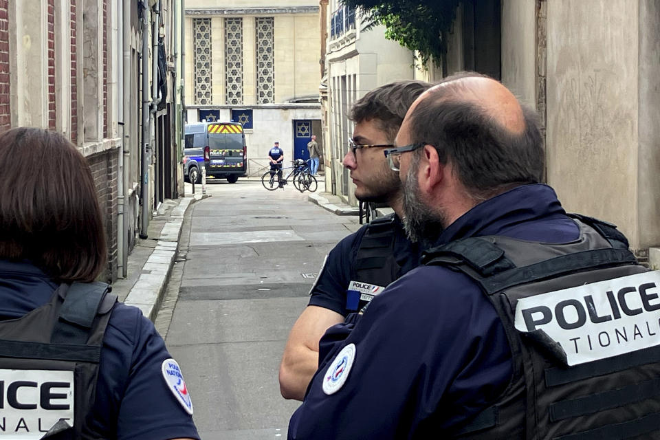 French policemen stand near the synagogue in Rouen, France, Friday, May 17, 2024. French police have shot and killed a man armed with a knife and a metal bar who is suspected of having set fire to a synagogue in the Normandy city of Rouen. (AP Photo/Oleg Cetinic)