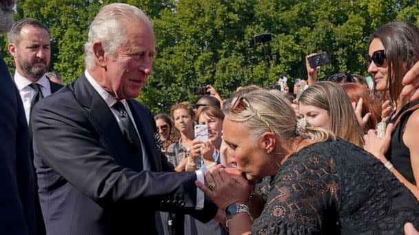 PHOTO: A well-wisher kisses the hand of Britain's King Charles III as he walks outside at Buckingham Palace following Thursday's death of Queen Elizabeth II, in London, Sept. 9, 2022. (Yui Mok/Pool via AP)