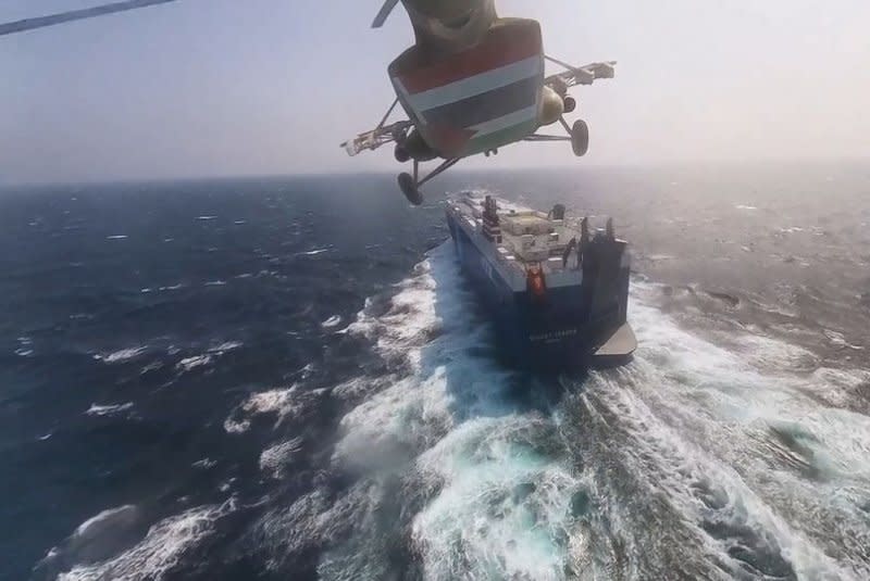 A Houthis-operated helicopter flies over the cargo ship Galaxy Leader in the Red Sea off the coast of Hodeidah, Yemen. The Houthis seized the ship while it was transiting the Red Sea, after threatening to target all ships owned or operated by Israeli companies or flying the Israeli flag. Photo courtesy of Houthis Media Center/EPA-EFE